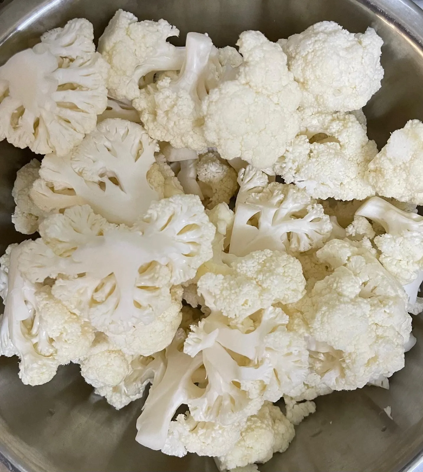 Step 1: Cut the cauliflower into small pieces.