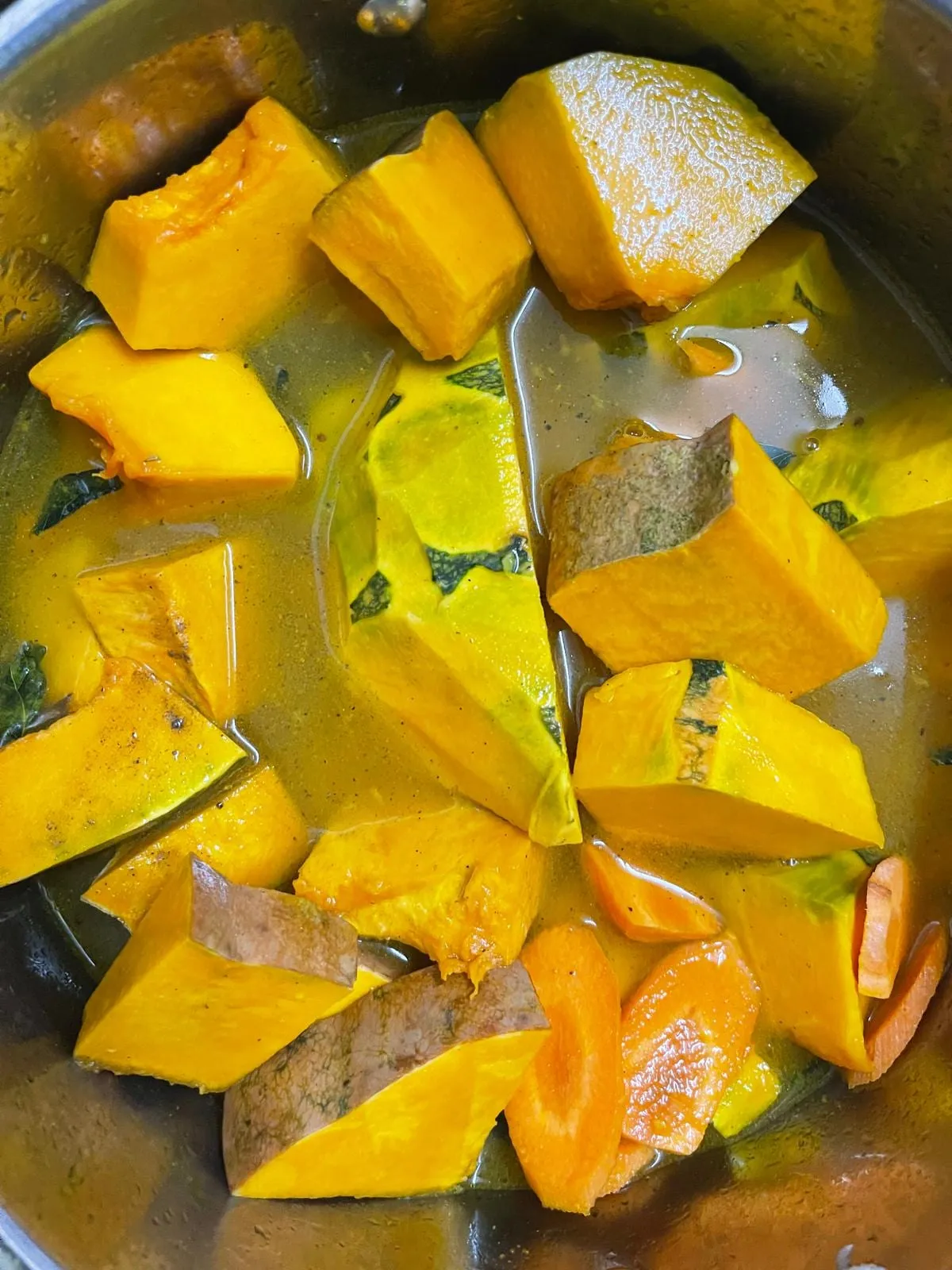 Step 3: In a large pot, combine the carrots and pumpkin, and add the sautéed spice mixture over th