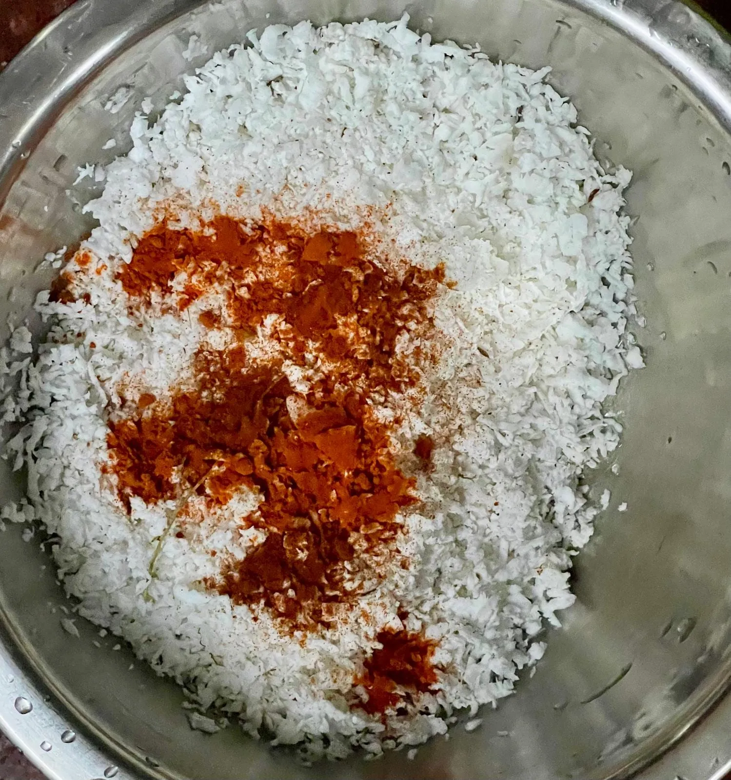 Step 3: In a medium bowl, combine the shredded coconut, Kashmiri chili powder, paprika, and lemon 