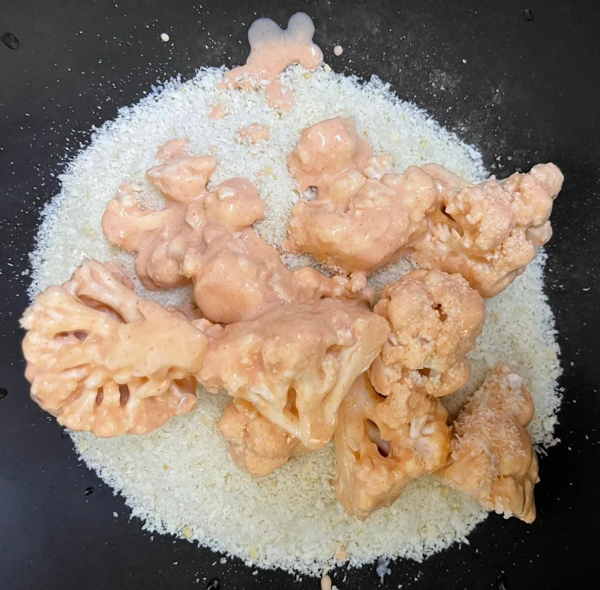 Step 3, photo 1: Add the cauliflower pieces and fold gently to coat them evenly in the batter.
