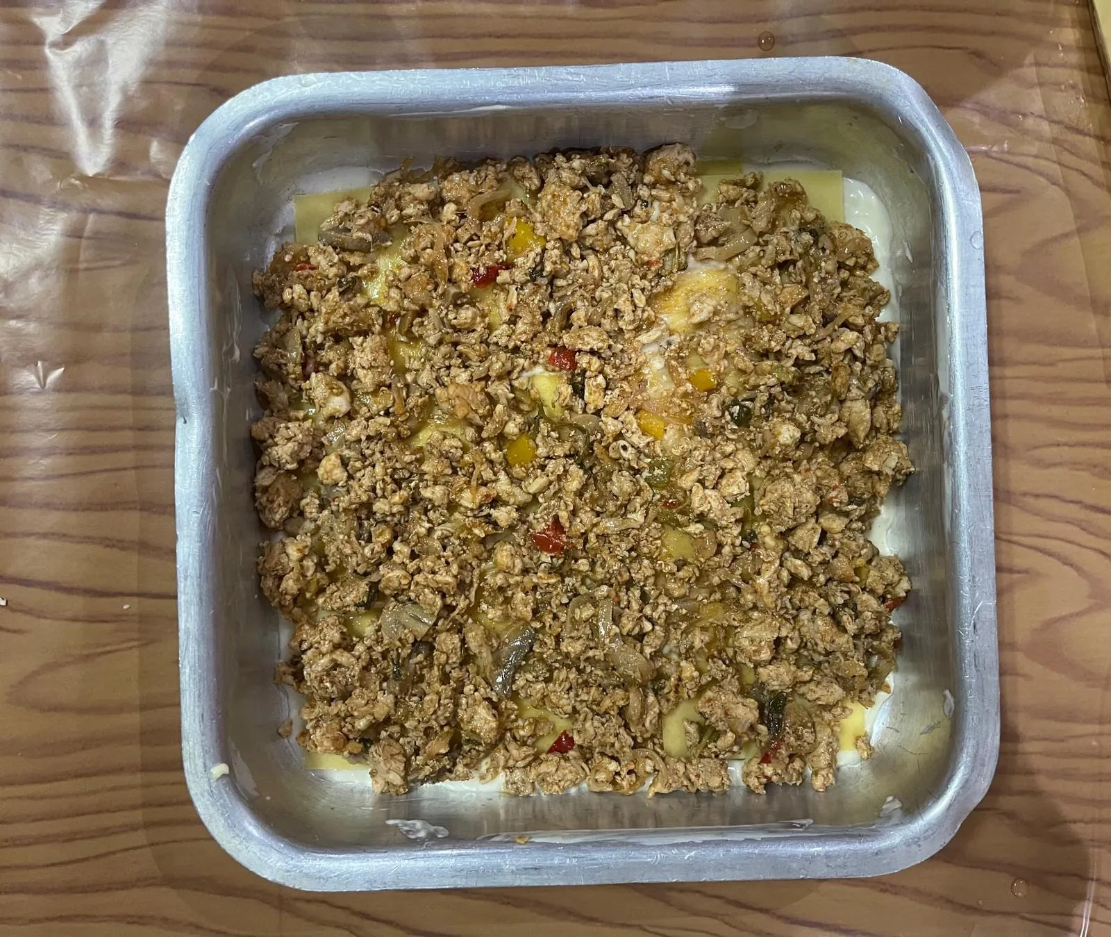 Step 4: Add about a 1-inch layer of your chosen meat filling over the pasta sheets.