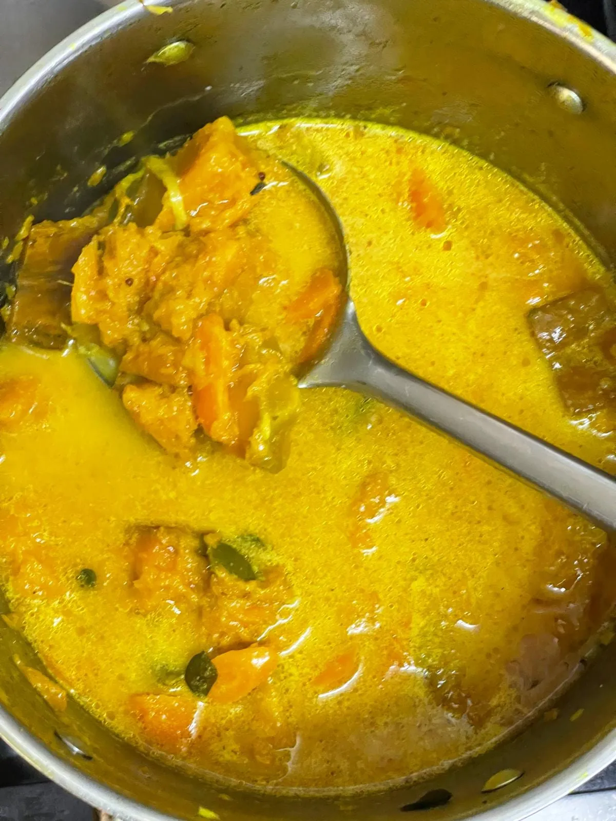 Step 5: Add the prepared coconut milk and roasted curry powder to the cooked vegetables. Stir gent