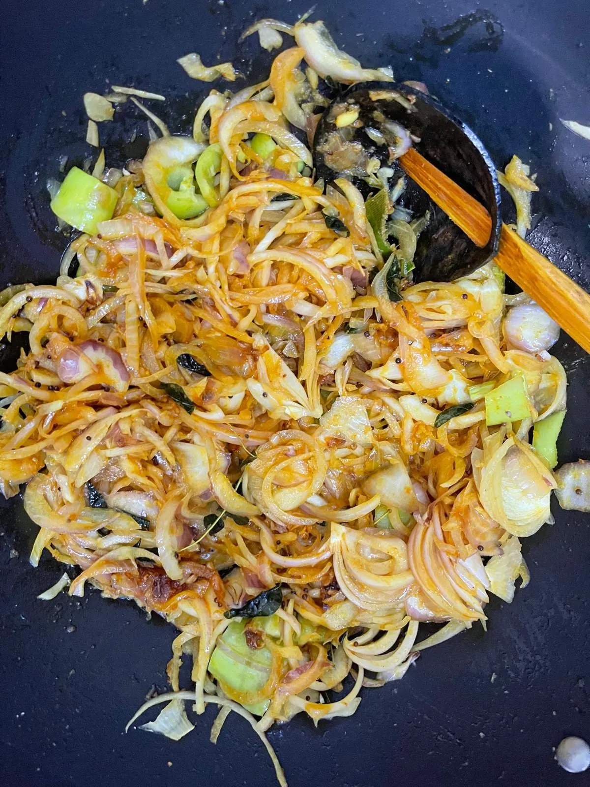 Step 6: Add the crushed ginger, crushed garlic, fennel seeds, cloves, and sliced onions. Stir, the