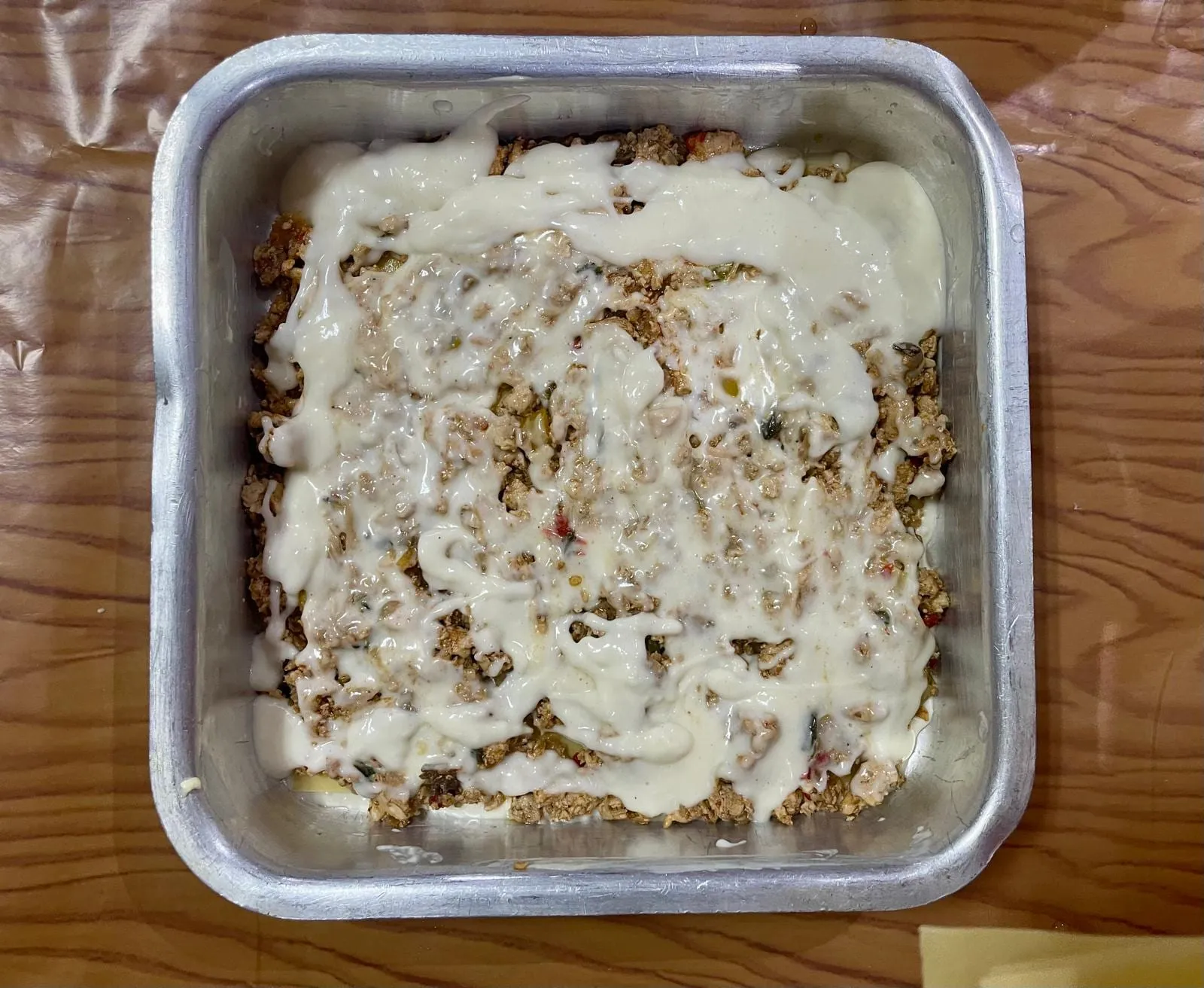 Step 5: Then add some sauce over the meat layer.
