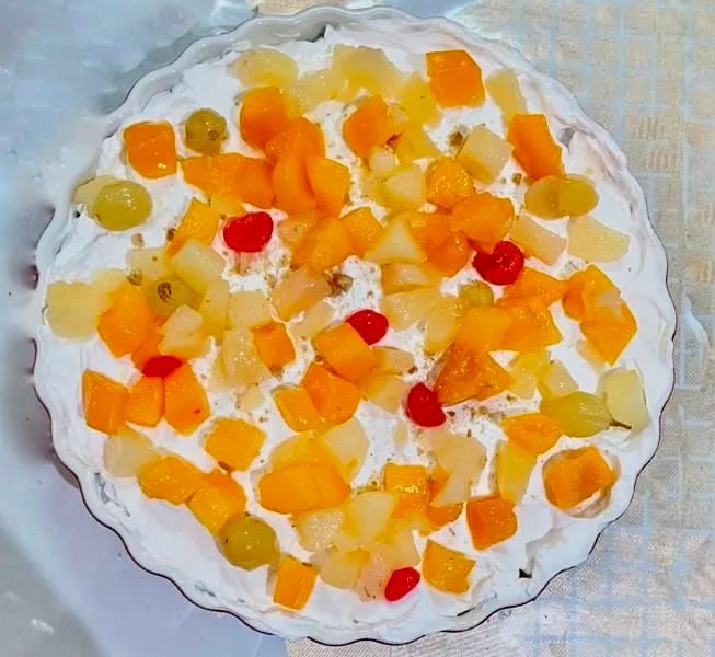 Step 5: Drain the mixed fruit and scatter it evenly over the whipped cream. Chill before serving i