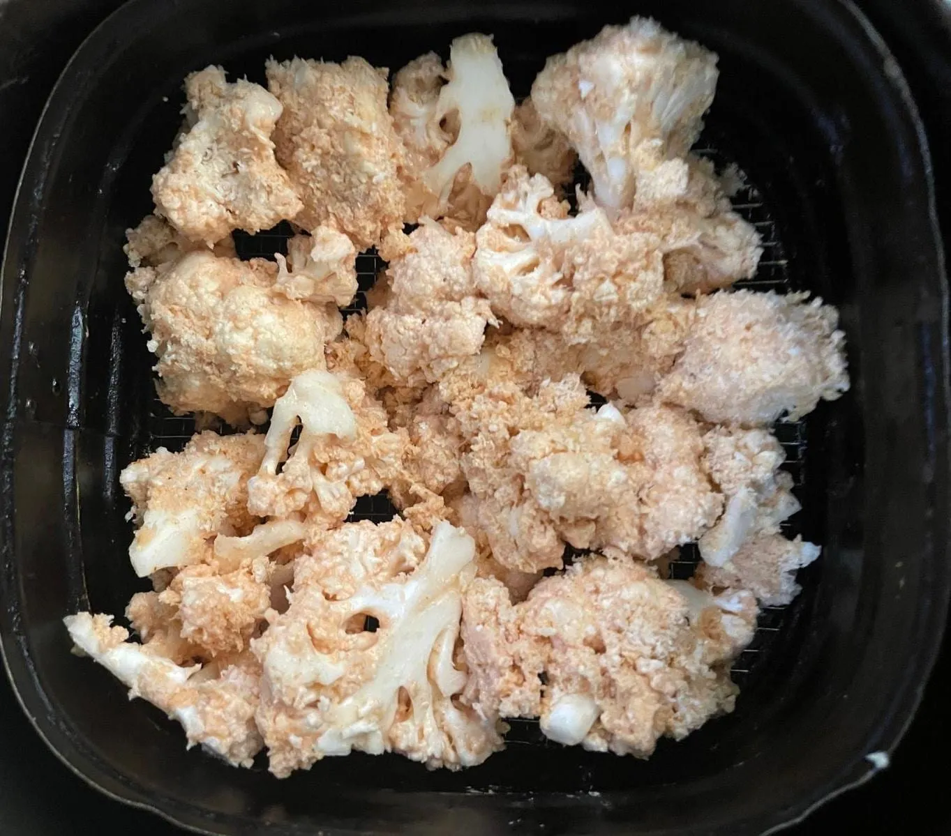 Step 5, photo 1: Place the cauliflower inside and air fry at 185°C for 9 minutes, shaking or tossing every 
