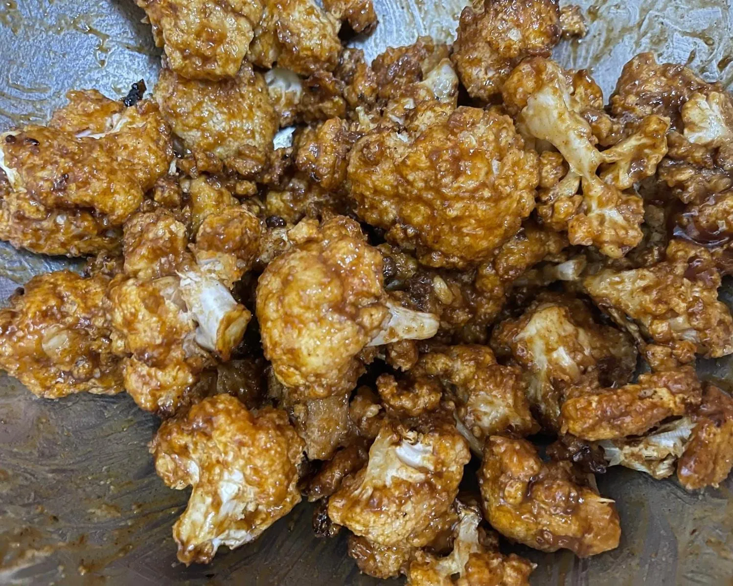 Step 7: Once the cauliflower is cooked, toss it in the sauce mixture until coated.