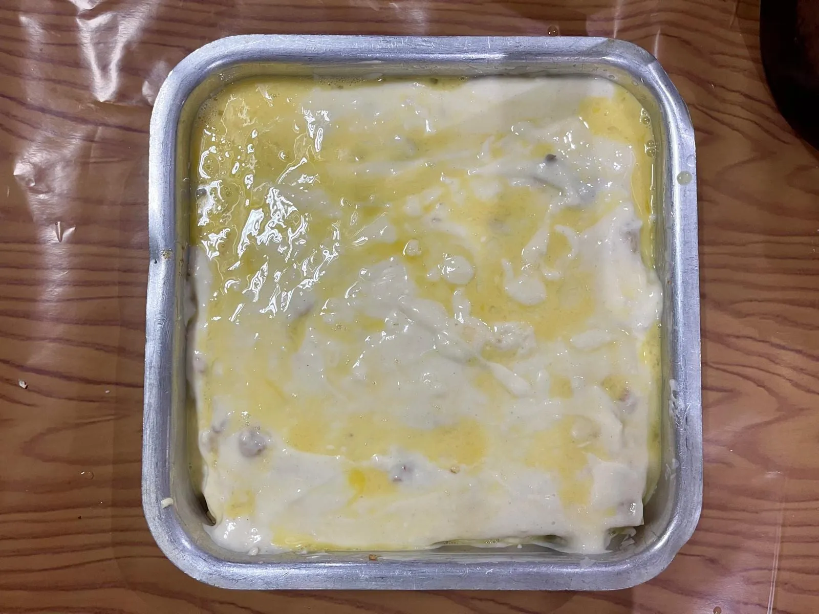 Step 8: Pour the beaten eggs evenly across the surface of the lasagna.